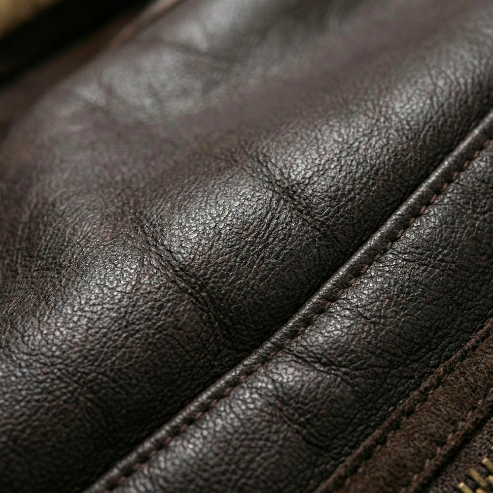 Detailed close-up shot showcasing the rich grain, supple texture, and high-quality finish of the genuine brown leather outer shell.